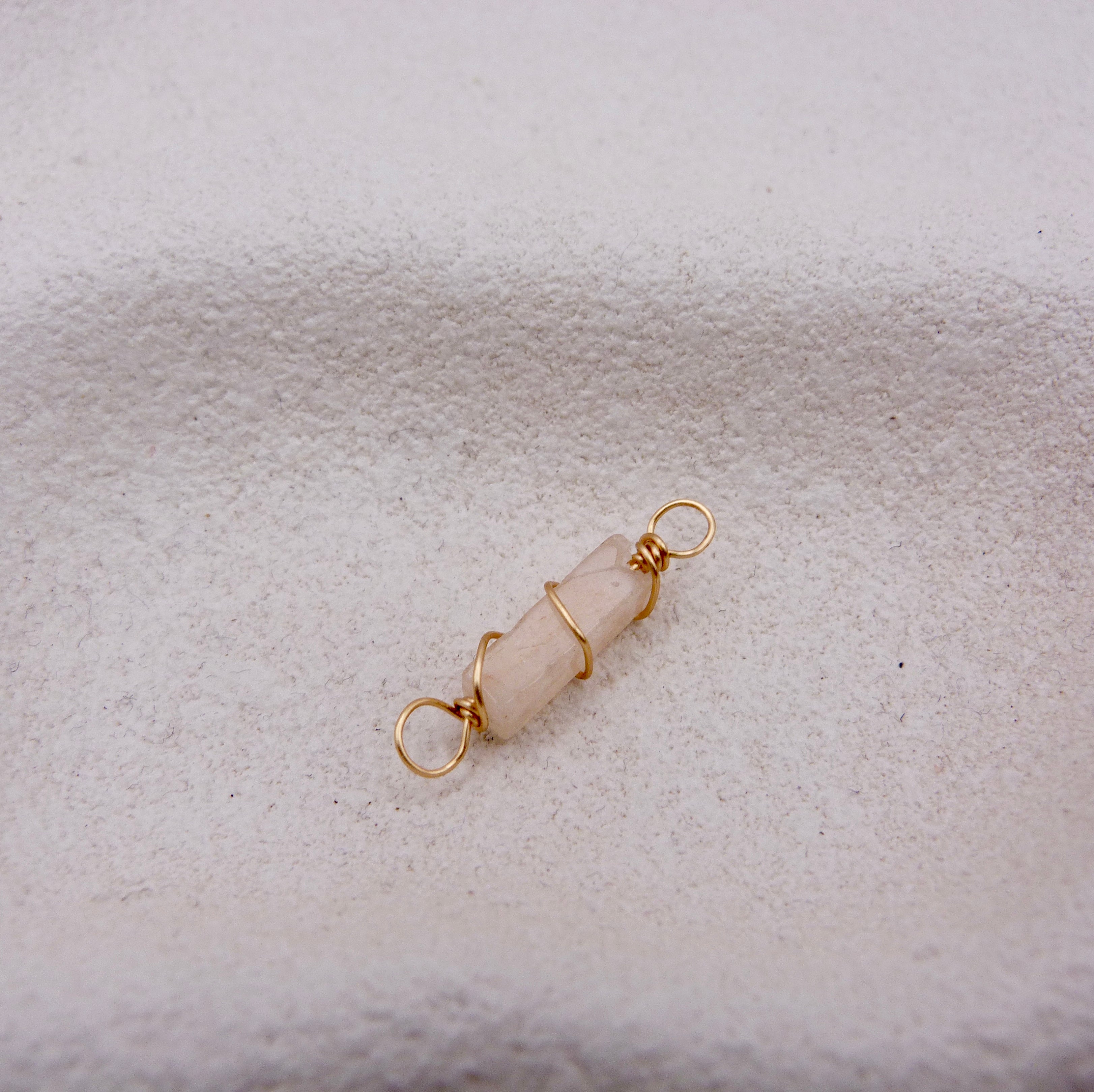 Gold-wire-wrapped beige pink crystal pendant