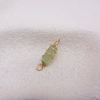 Light green crystal pendant with gold wire wrapping