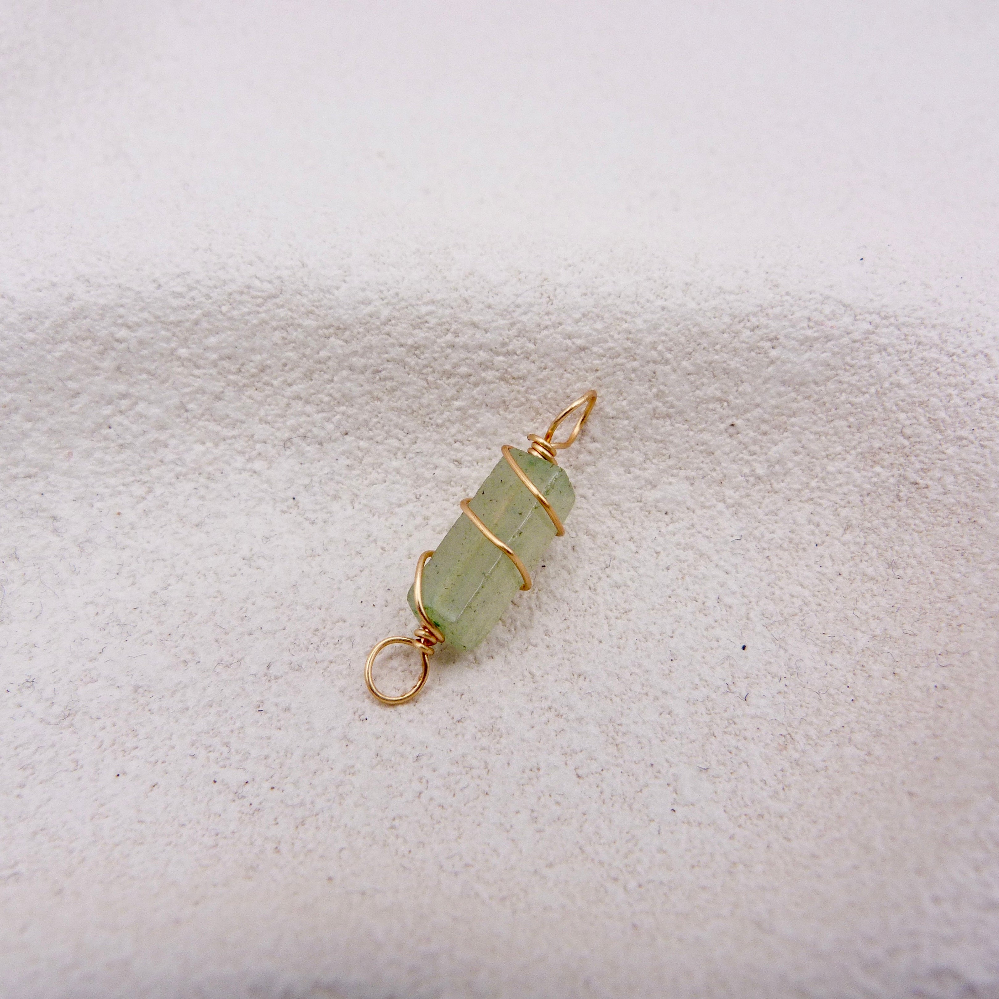 Light green crystal pendant with gold wire wrapping