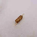 Brown stone wrapped in gold wire 