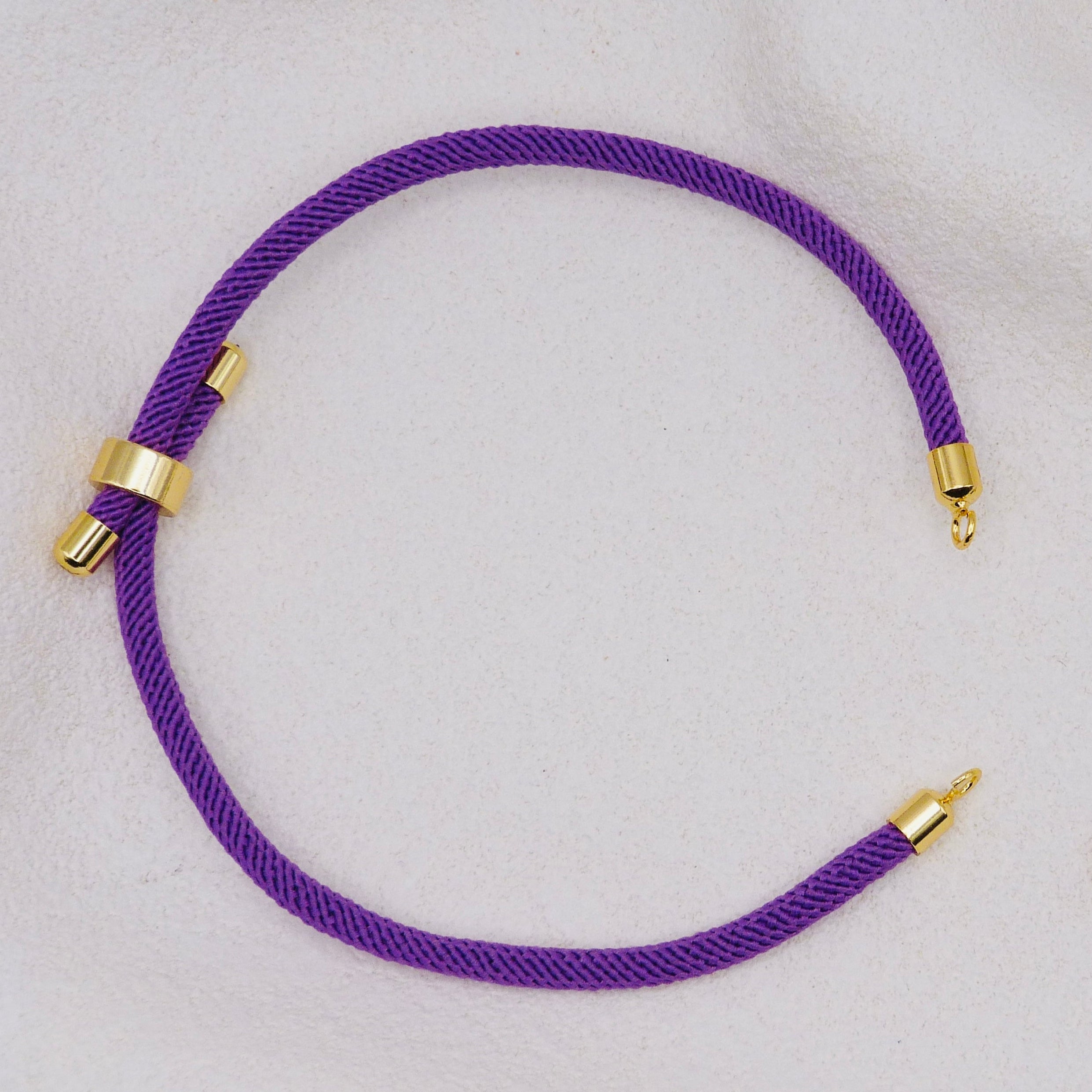 Purple rope necklace with gold clasps. The bracelet has a gap to cutomise.