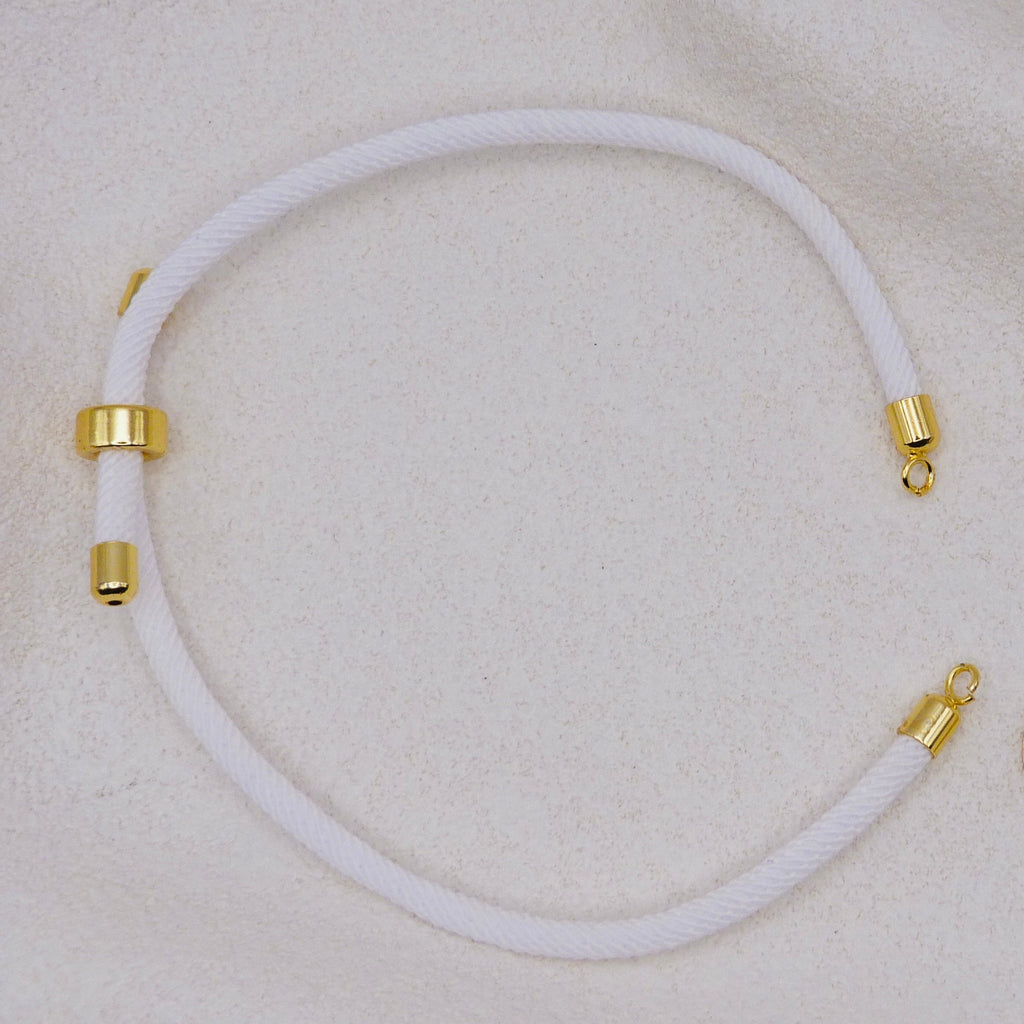White rope necklace with gold clasps. The bracelet has a gap to cutomise.