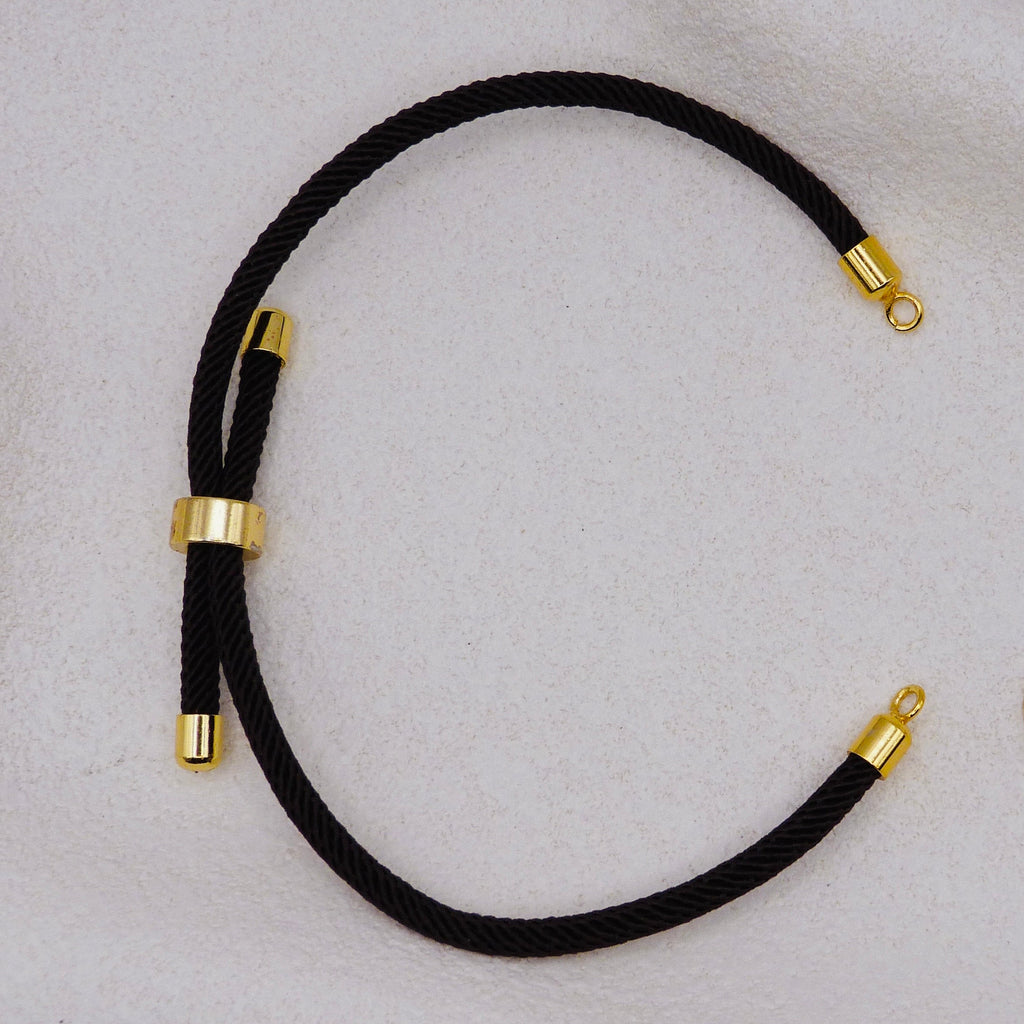 Black rope necklace with gold clasps. The bracelet has a gap to cutomise.