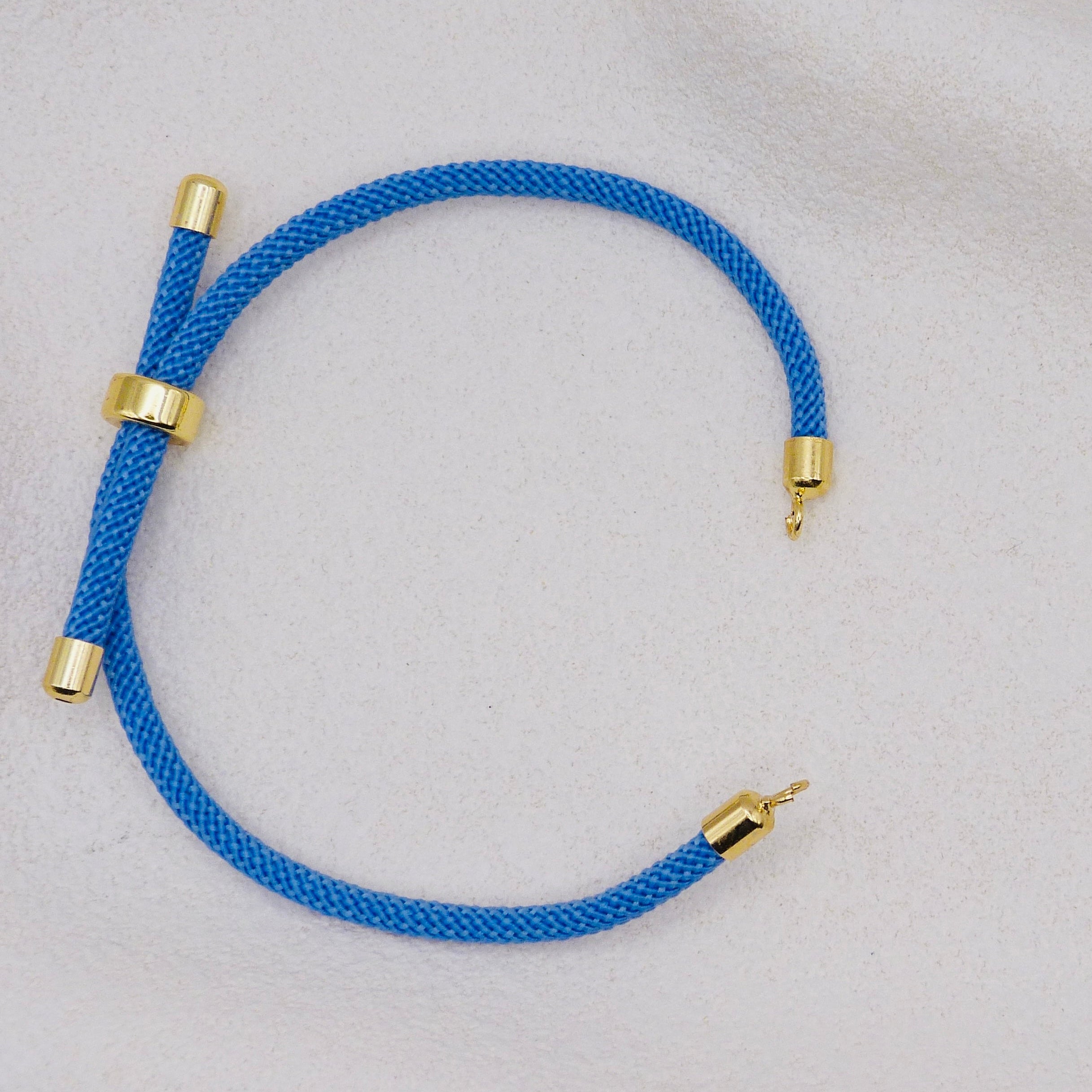 Blue rope necklace with gold clasps. The bracelet has a gap to cutomise.