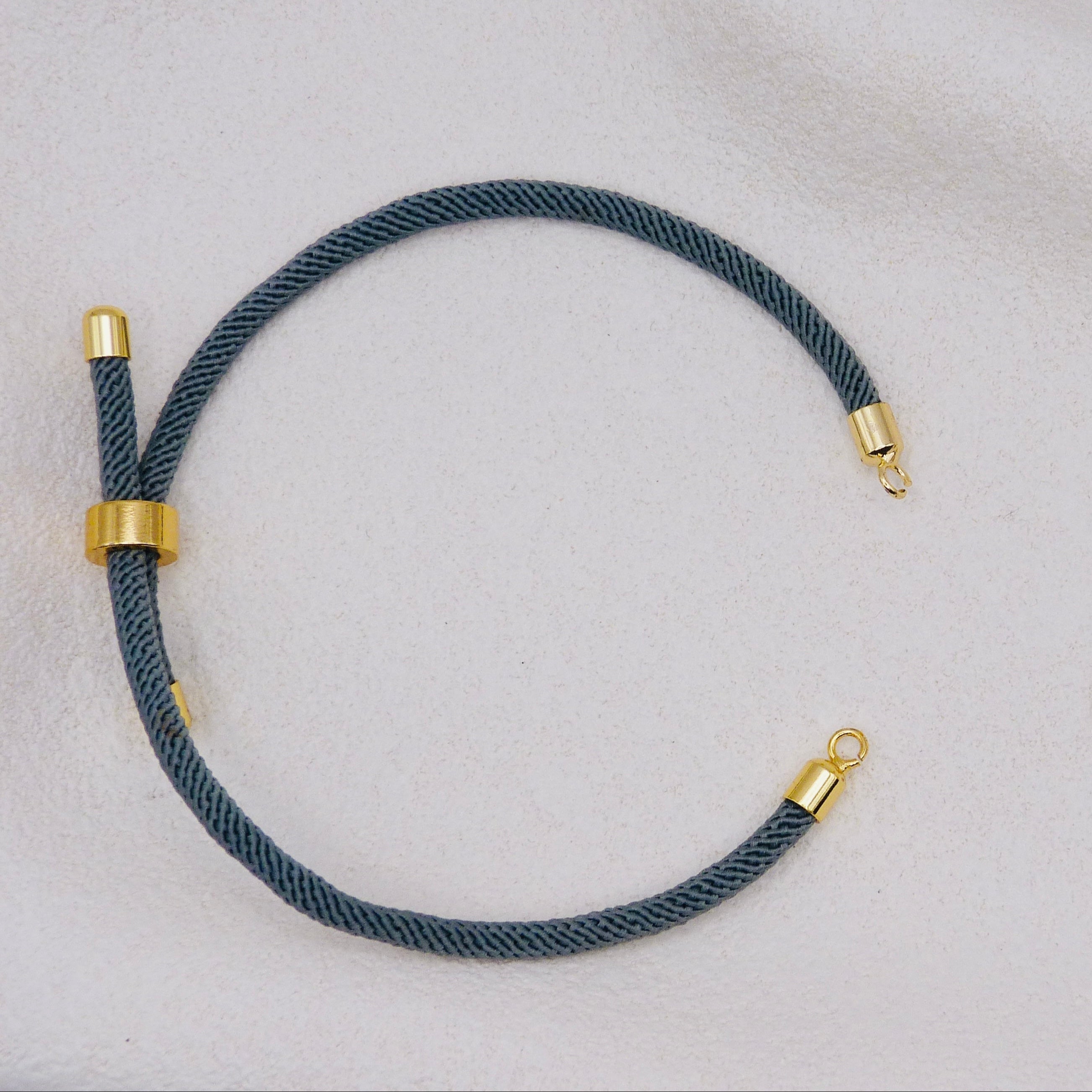 Gray rope necklace with gold clasps. The bracelet has a gap to cutomise.