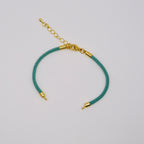 Waterpoof teal green nylon bracelet with gold adjustable chain in stainless steel.