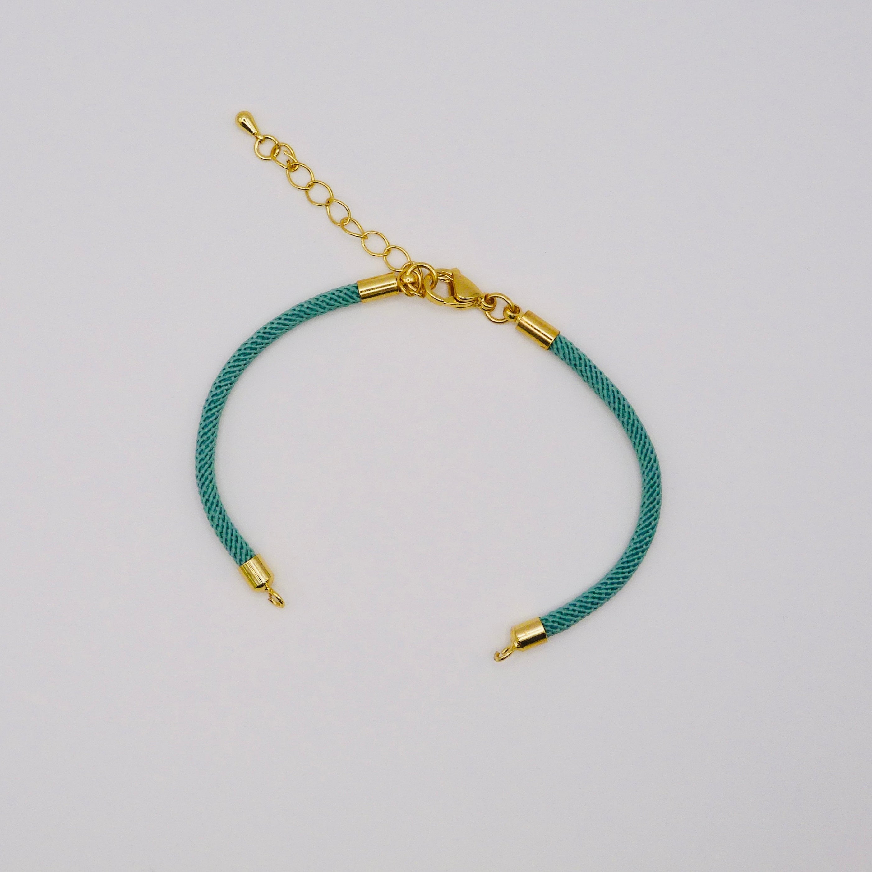 Waterpoof teal green nylon bracelet with gold adjustable chain in stainless steel.