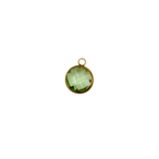 Green circular glass charm with waterproof gold frame.