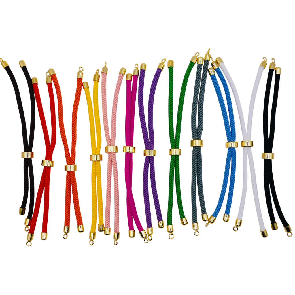 Set of colorful braided cords with gold ends on a white background