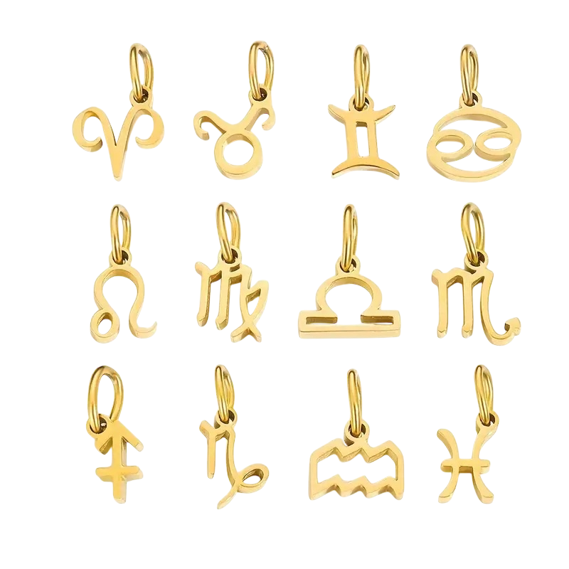 Gold zodiac charm pendants on a white background