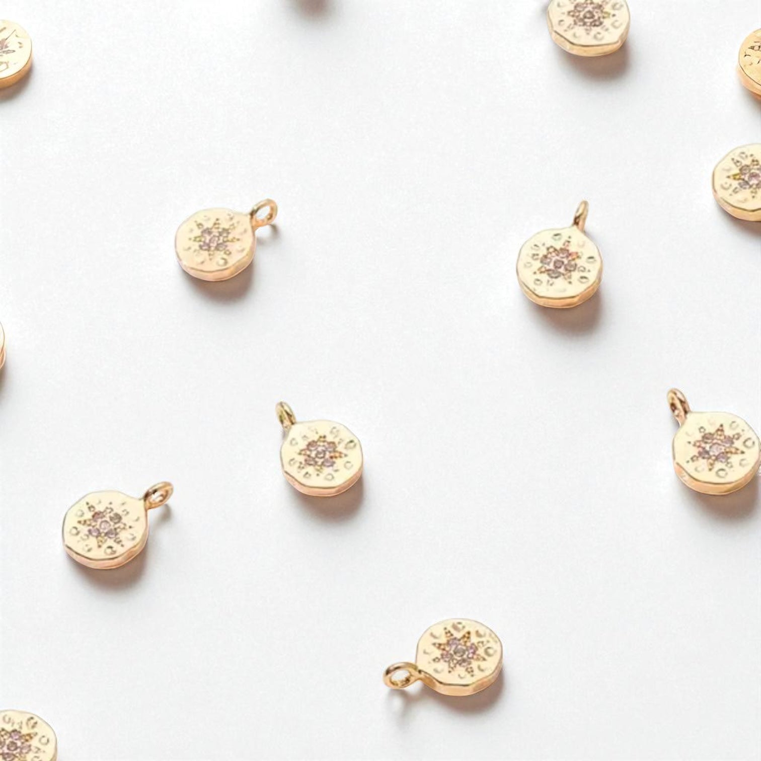 Gold zirconia charm with diamond-like stones.