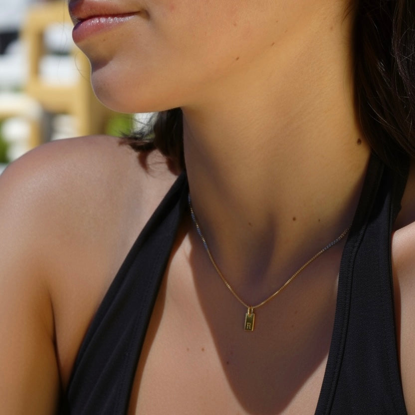 Gold box chain necklace with a letter engraved charm in stainless steel.