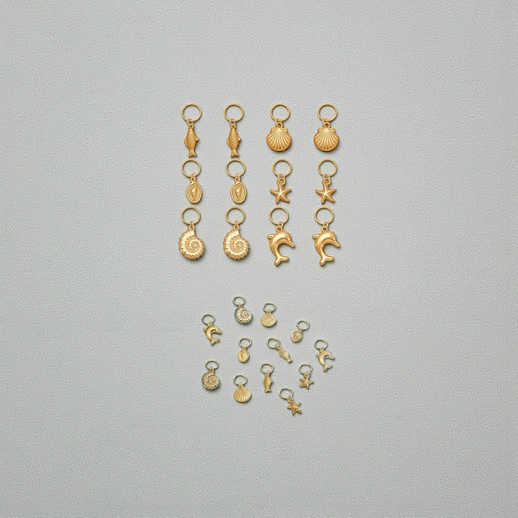 Collection of small gold charms on a gray background