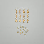 Collection of small gold charms on a gray background