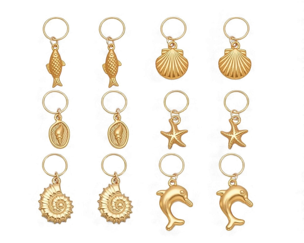 Collection of gold bikini charms with various sea-themed designs on a white background