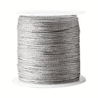 Spool of silver nylon thread for customisable necklaces.