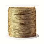 Spool of gold nylon thread for customisable necklaces.