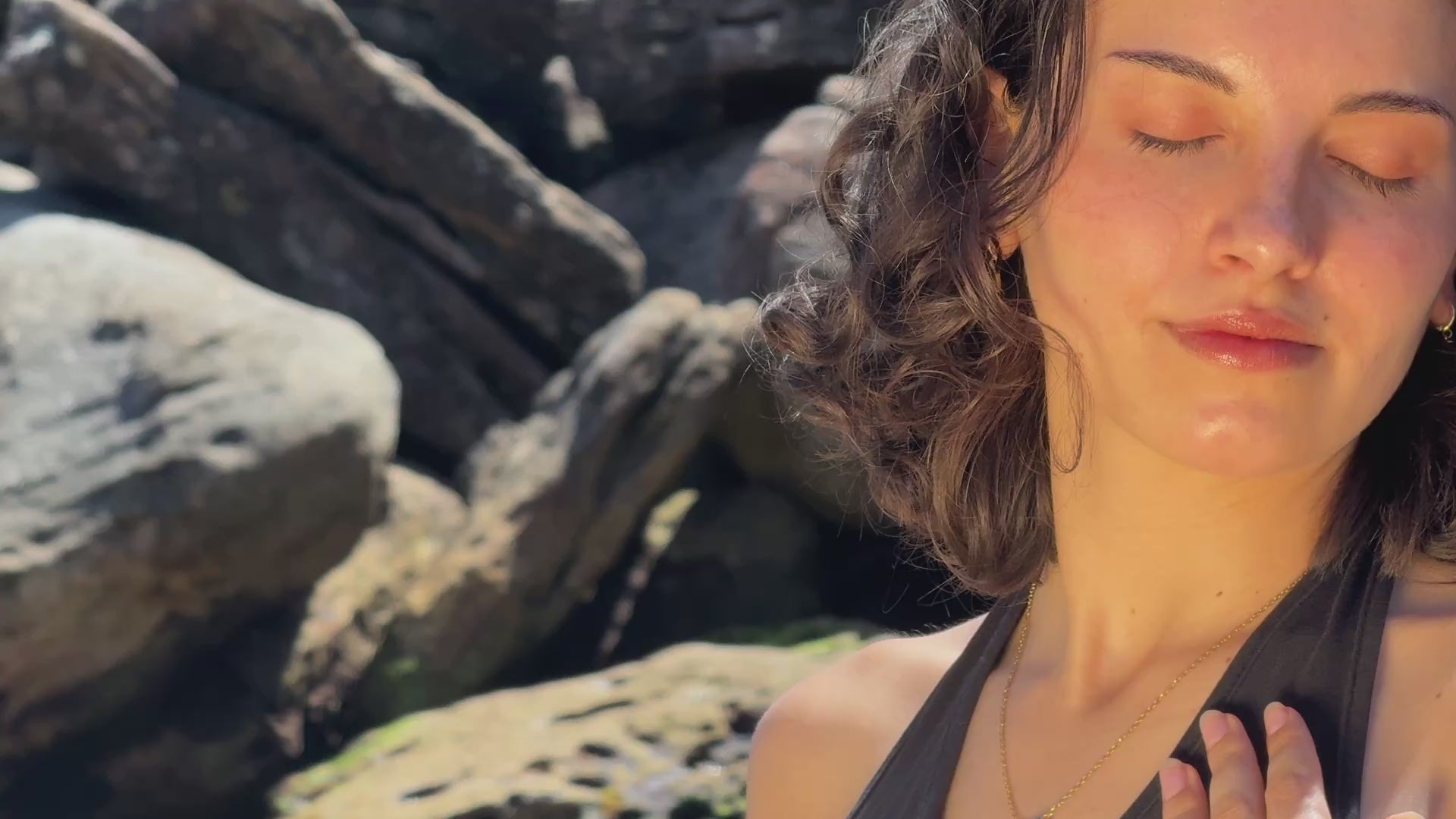 Woman wearing the snake bracelet with a link to which is attached the green circle glass charm.